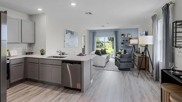 a kitchen with a sink dishwasher a stove and a refrigerator with wooden floor
