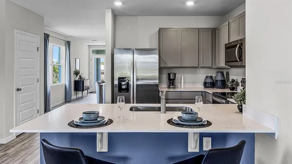 a kitchen with furniture and a kitchen area