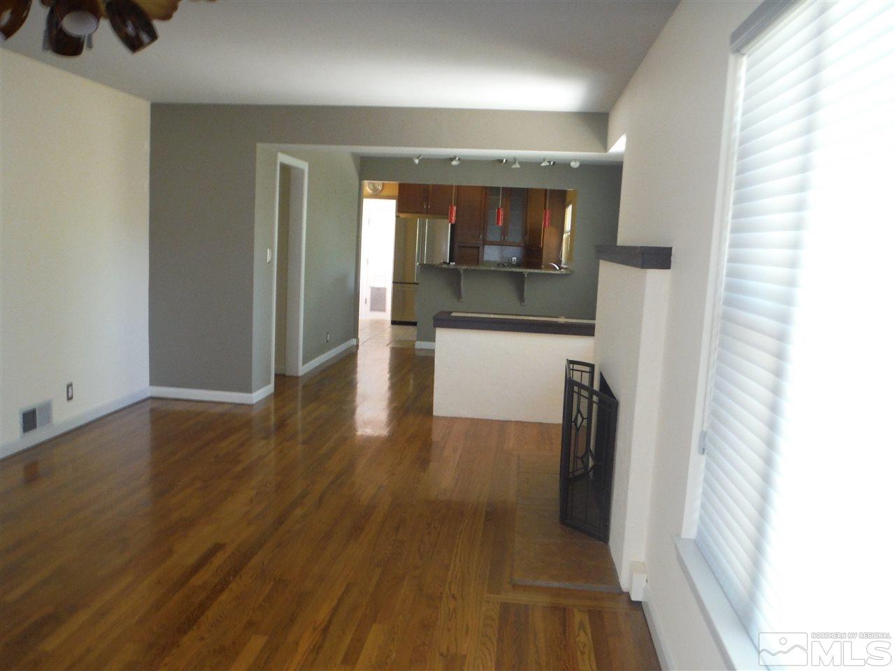 675 Robin Street Reno, NV 89509 - Photo 4 of 7 a view of a hallway view with wooden floor and staircase