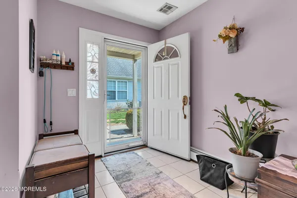 a view of a hallway with potted plant and a living room