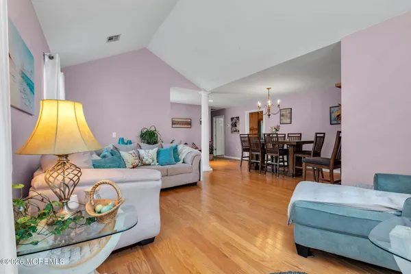 a living room with furniture and a dining area