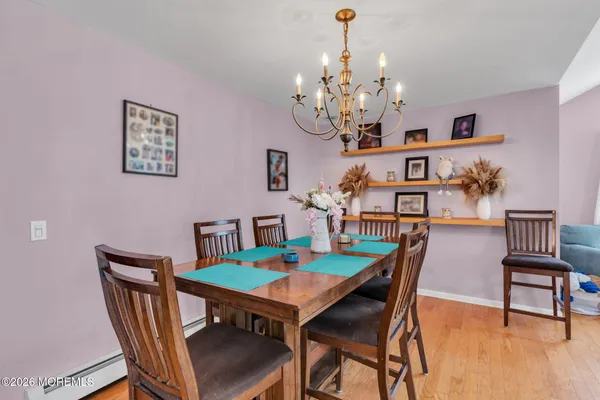 a view of a dining room with furniture and wooden floor