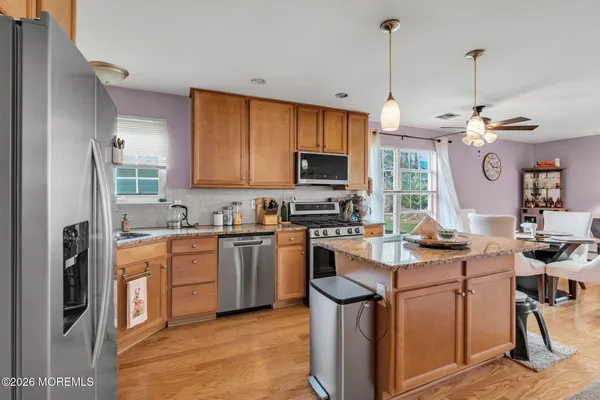 a kitchen with kitchen island a sink stove and refrigerator