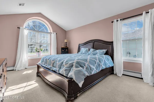 a bedroom with a bed lamp and window