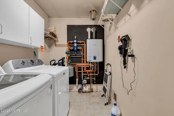 a view of storage and utility room with washer and dryer