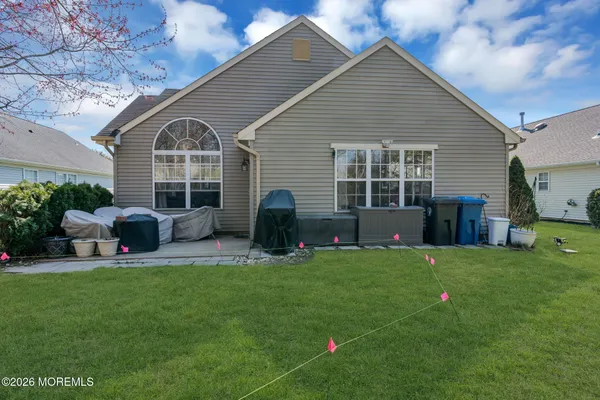 a view of a house with a backyard and a patio
