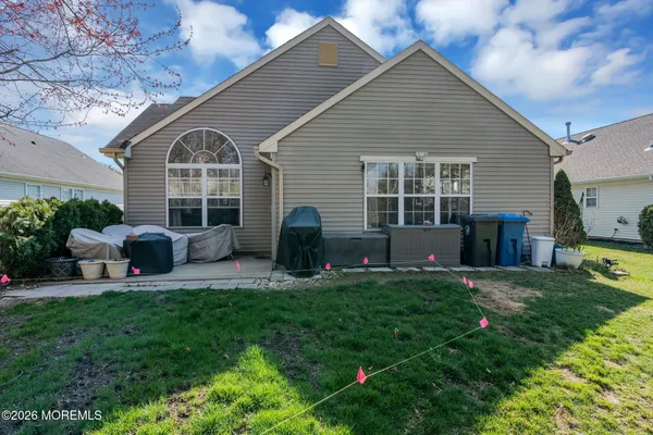 a view of a house with a backyard and a patio