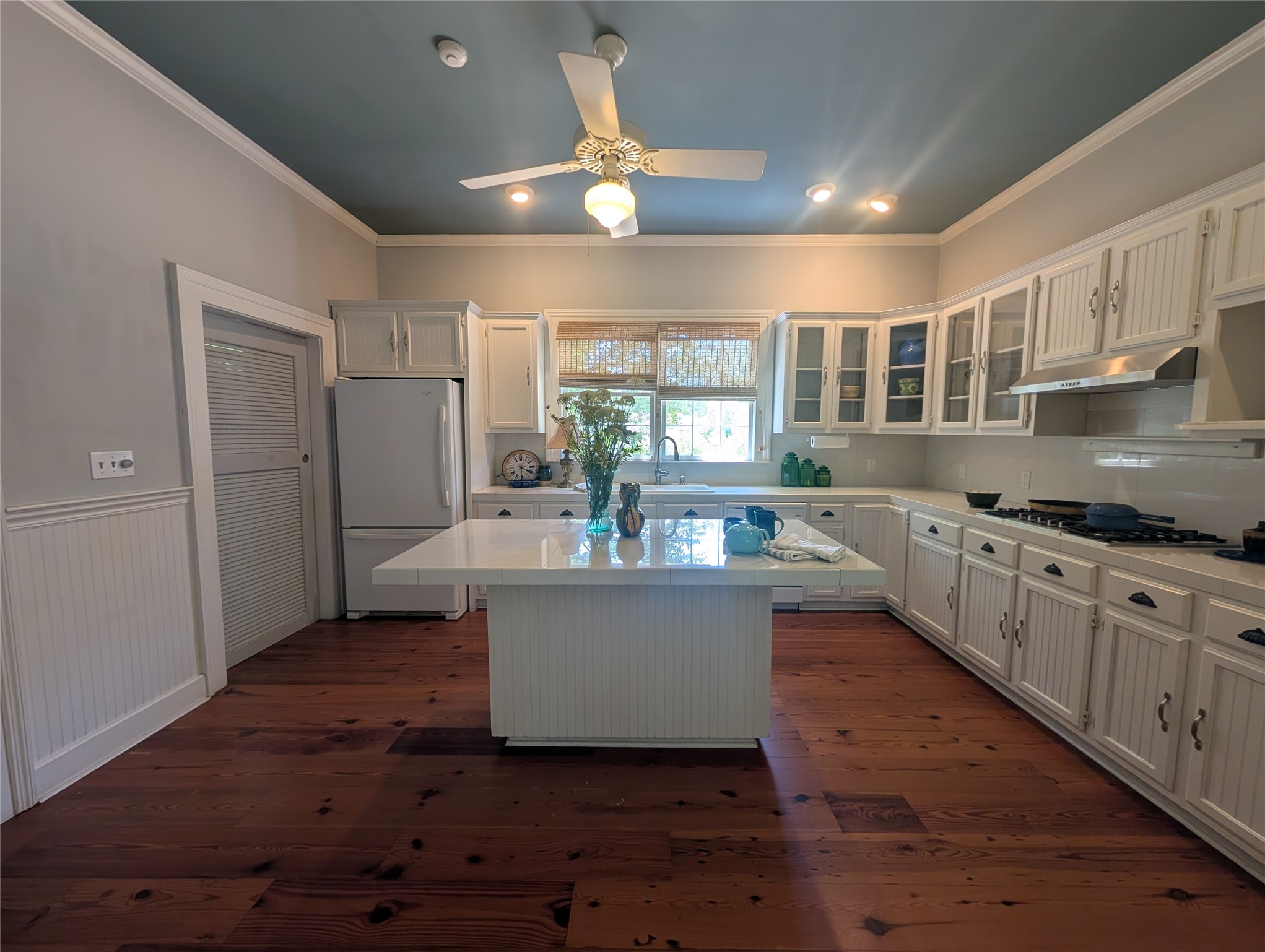 414 Spring Street Washington, GA 30673 - Photo 10 of 42 a kitchen with stainless steel appliances granite countertop a stove a sink dishwasher a refrigerator and white cabinets with wooden floor
