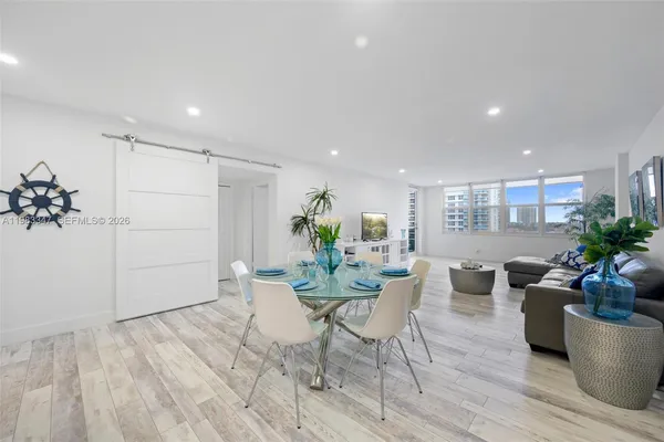 a view of a dining room with furniture window and wooden floor