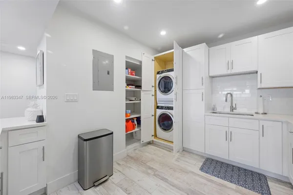 a utility room with sink dryer and washer