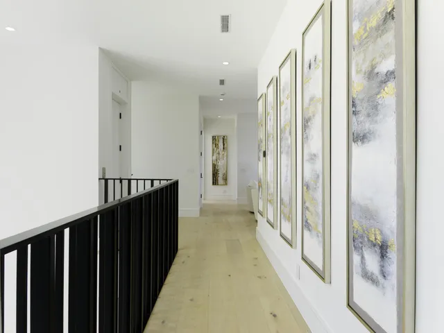 a view of a hallway with wooden floor and glass door