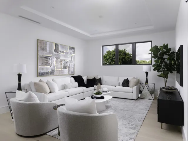 a living room with furniture a large window and a flat screen tv
