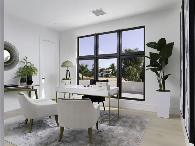 a living room with furniture a large window and a potted plants