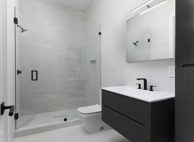 a bathroom with a sink toilet and shower