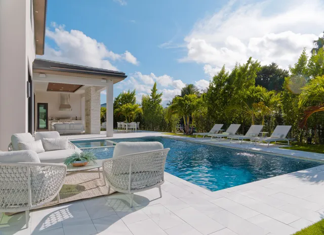 a view of swimming pool with outdoor seating and plants