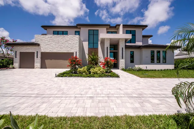 a front view of a house with a yard and a garage