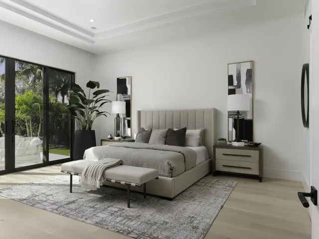 a bedroom with a bed and large window