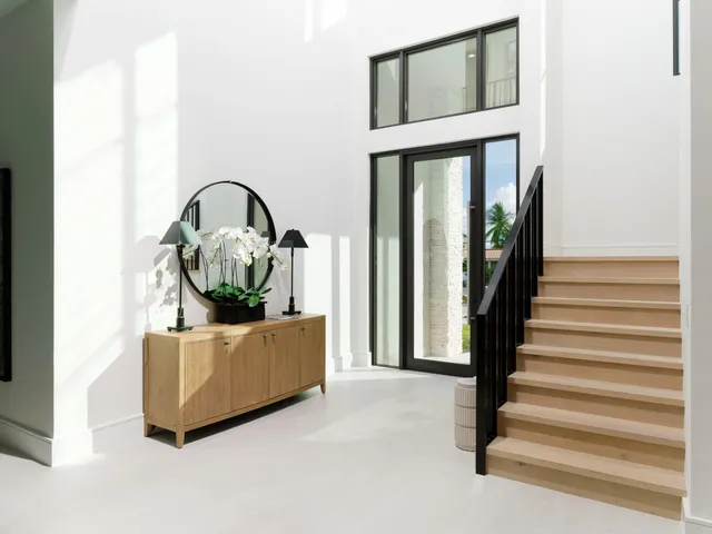 a living room with furniture and a mirror