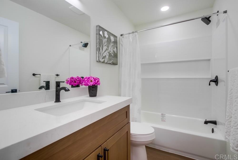 8301 Mission Gorge Road, Unit 331 Santee, CA 92071 - Photo 15 of 17 a bathroom with a sink vanity mirror and toilet