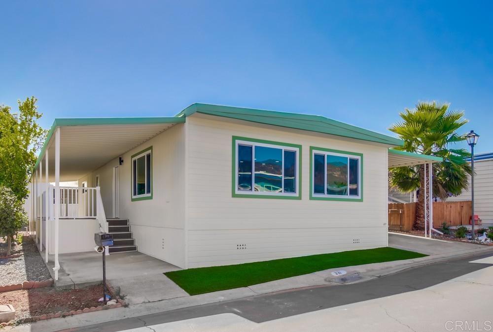 8301 Mission Gorge Road, Unit 331 Santee, CA 92071 - Photo 2 of 17 a front view of a house with a yard and garage