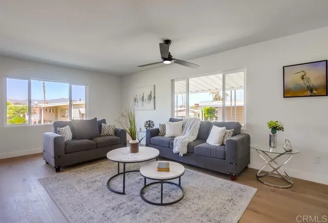 a living room with furniture and kitchen view