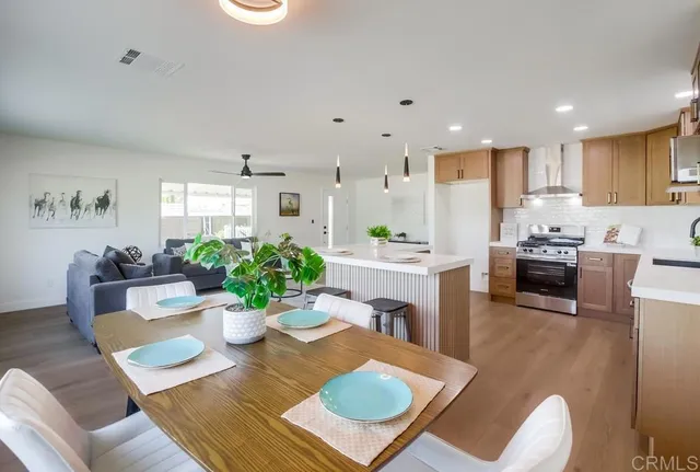 a kitchen that has a sink a stove top oven a counter space and cabinets