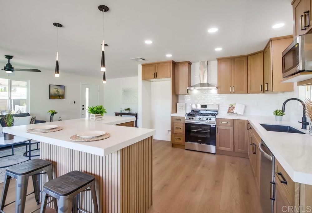 8301 Mission Gorge Road, Unit 331 Santee, CA 92071 - Photo 7 of 17 a kitchen that has a sink a stove top oven a counter space and cabinets