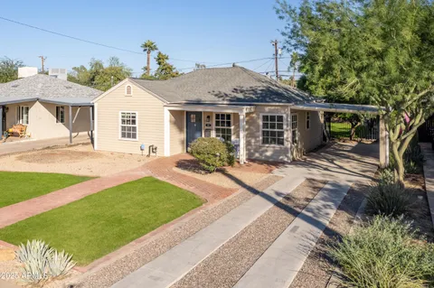a front view of a house with a garden and patio