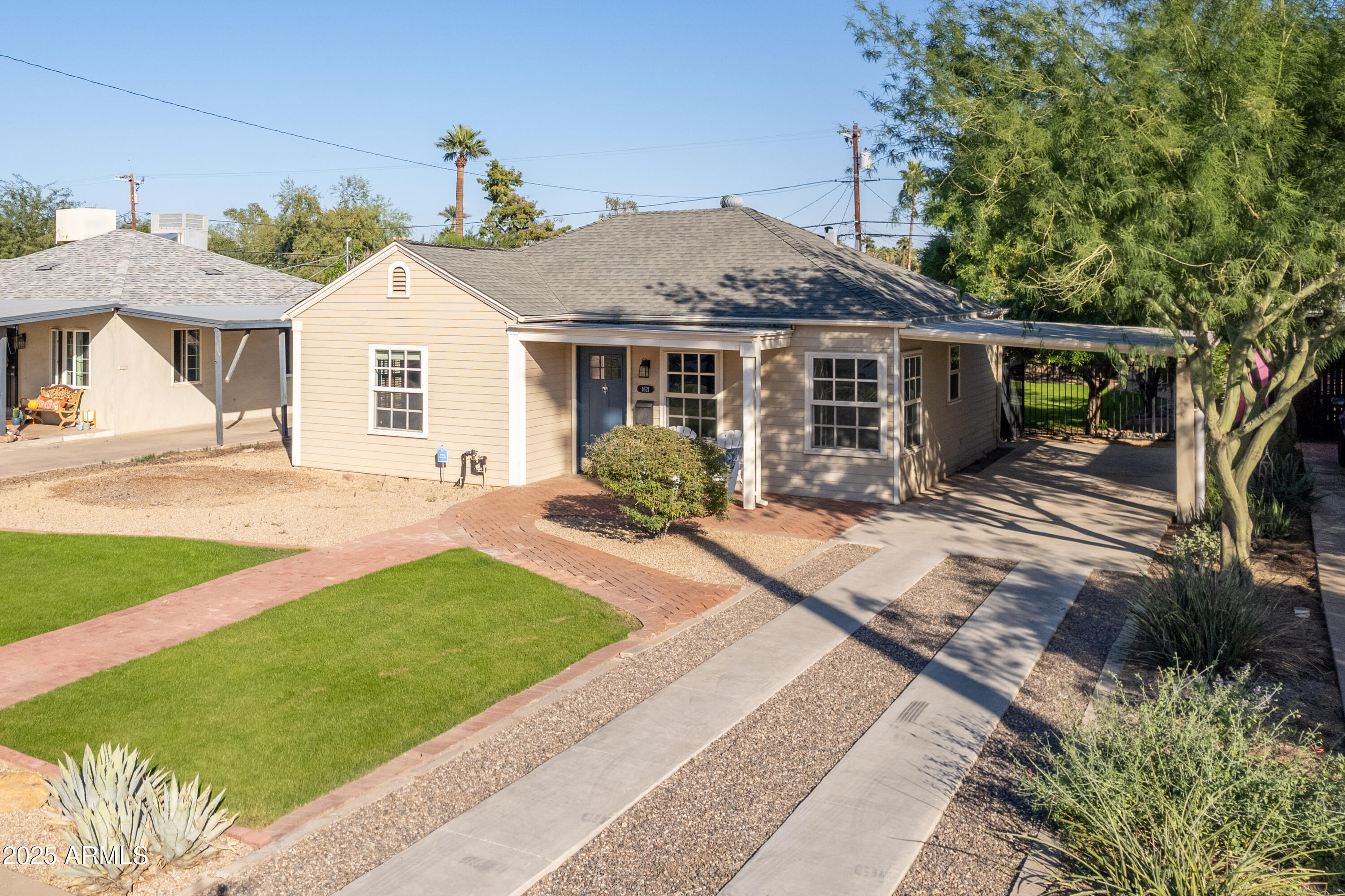 a front view of a house with a garden and patio