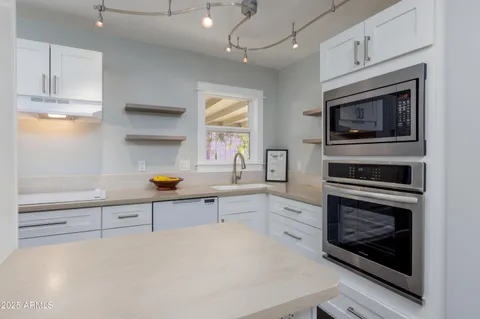 a kitchen with stainless steel appliances a stove a microwave and cabinets