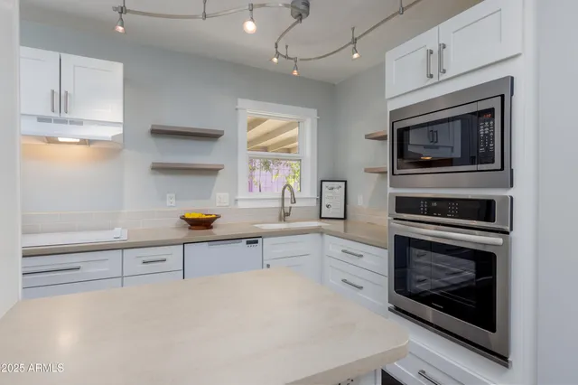 a kitchen with stainless steel appliances a stove a microwave and cabinets