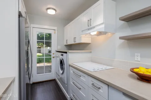 a kitchen with a sink a stove and cabinets