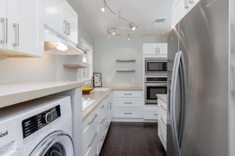 a kitchen with stainless steel appliances a refrigerator and a stove