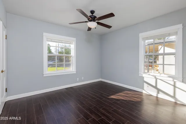 a view of an empty room with wooden floor