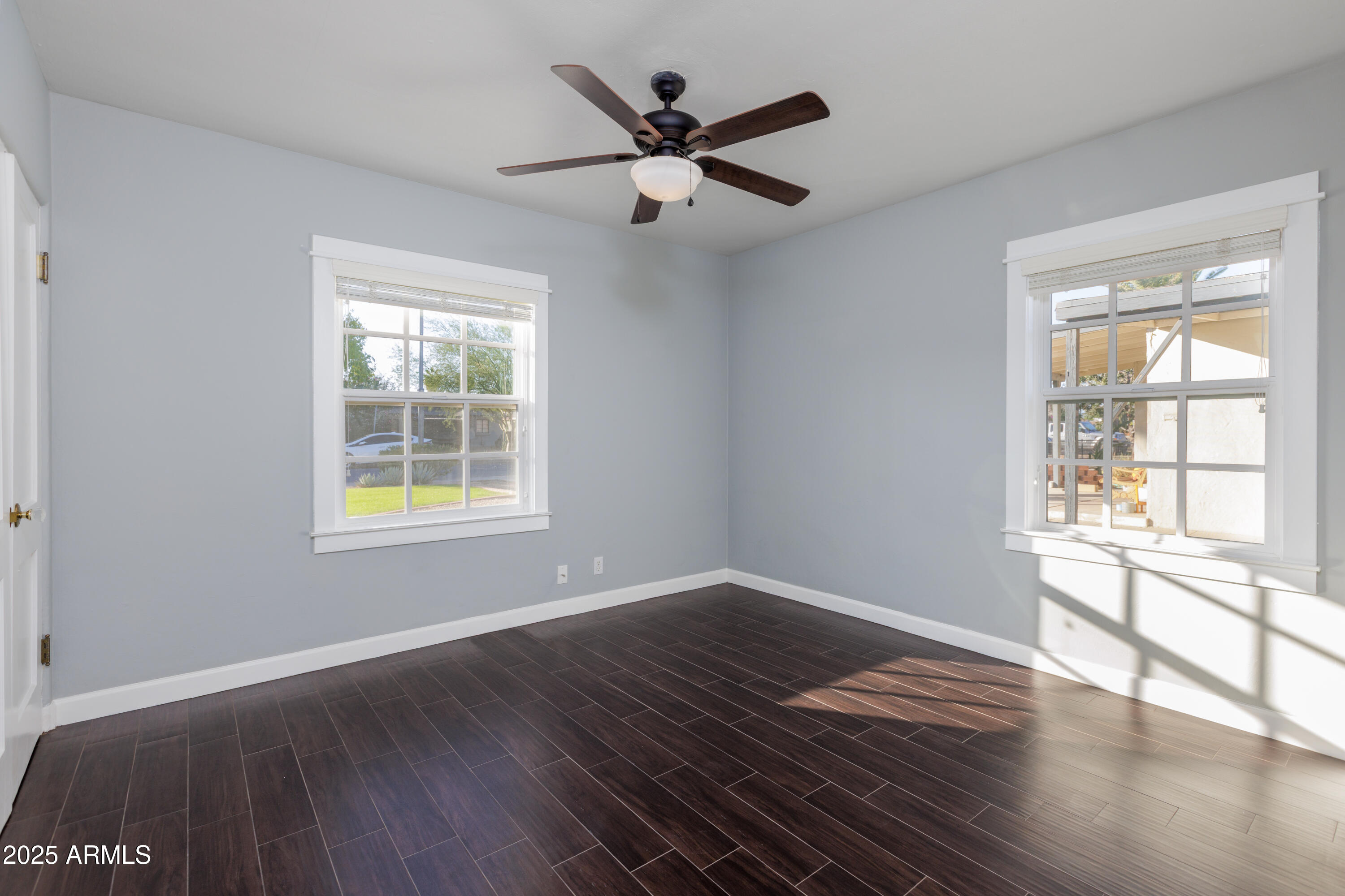 1621 North 16th Avenue Phoenix, AZ 85007 - Photo 20 of 32 an empty room with wooden floor and windows