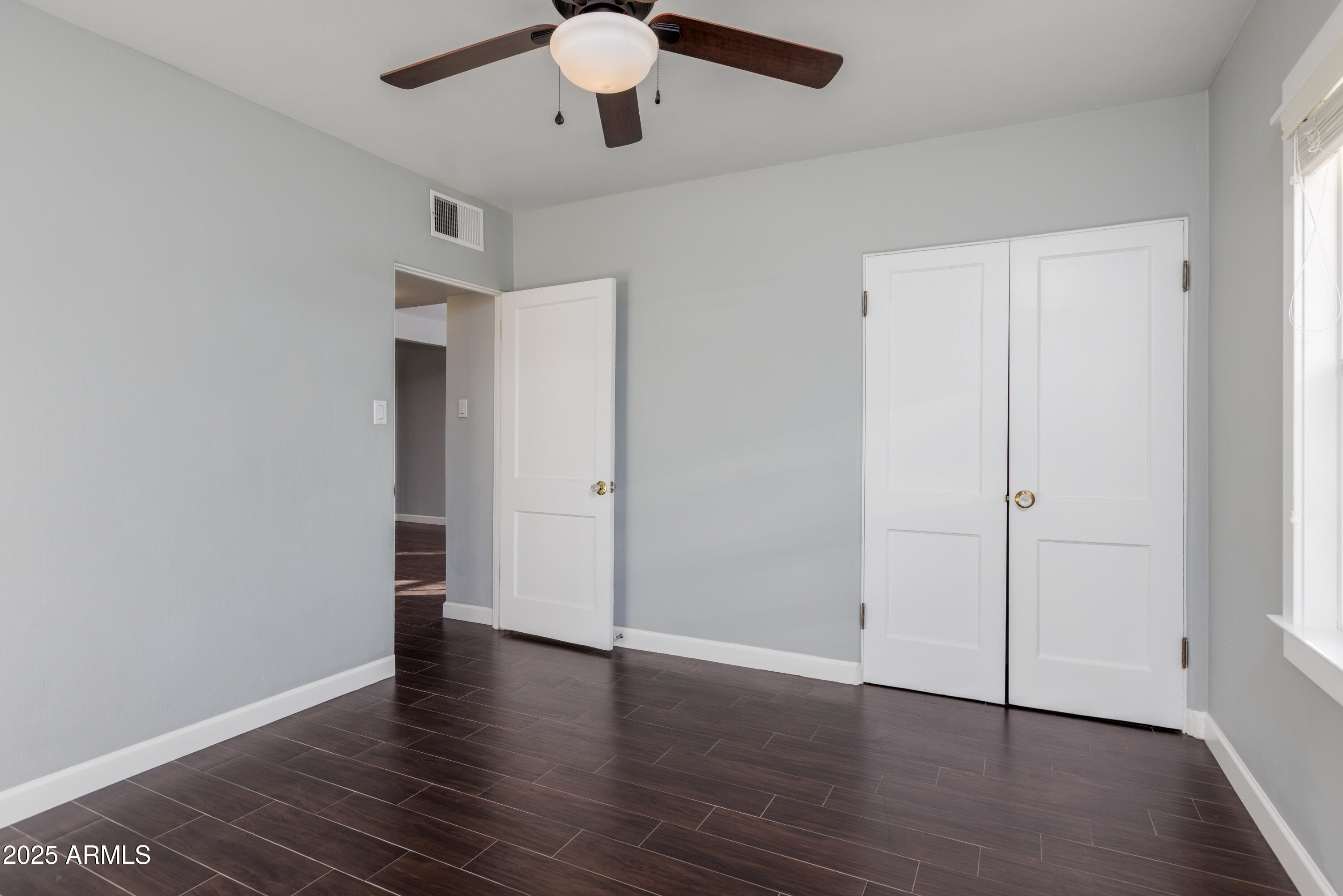 1621 North 16th Avenue Phoenix, AZ 85007 - Photo 21 of 32 a view of an empty room with wooden floor