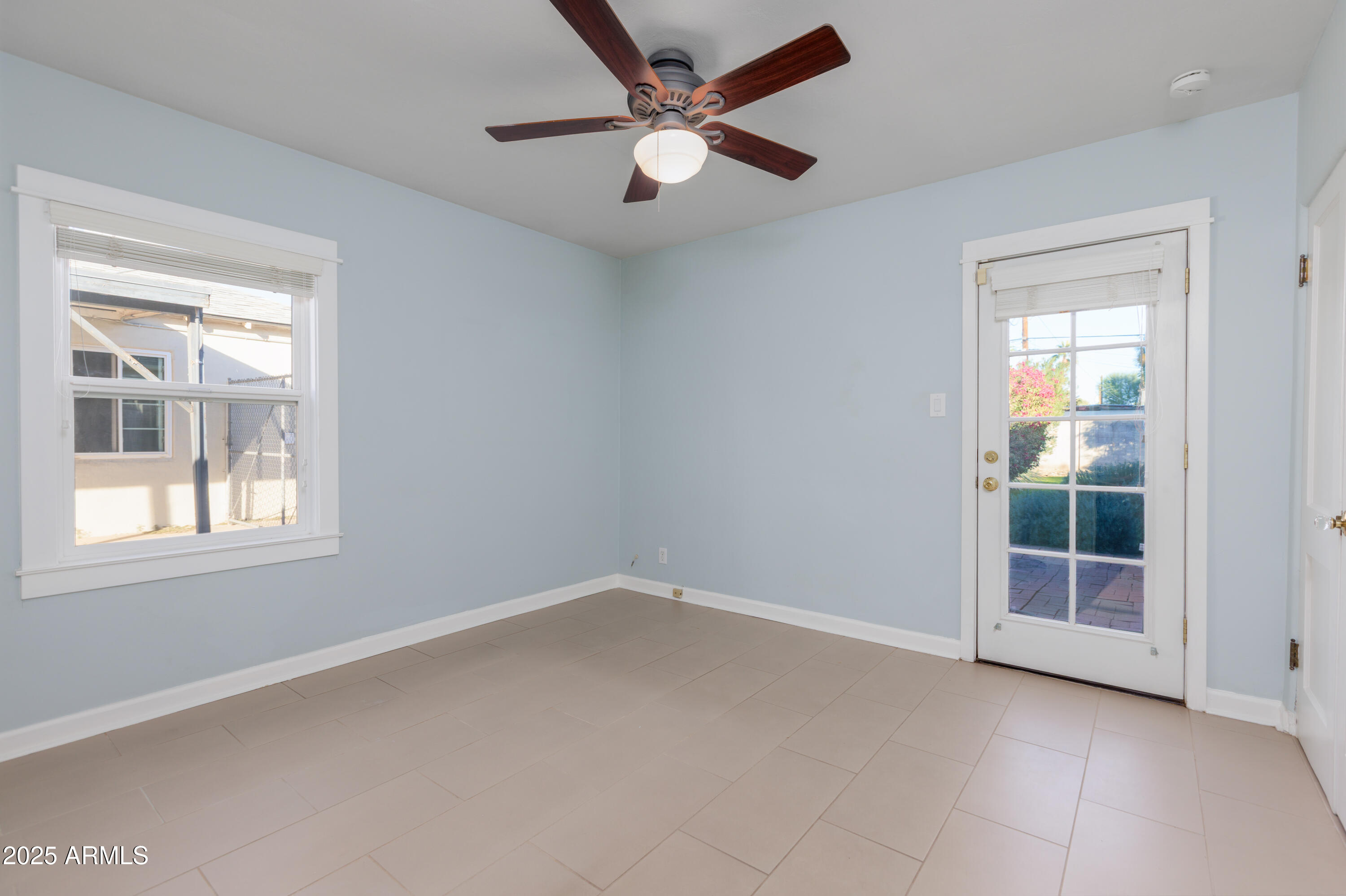1621 North 16th Avenue Phoenix, AZ 85007 - Photo 22 of 32 an empty room with window and a ceiling fan
