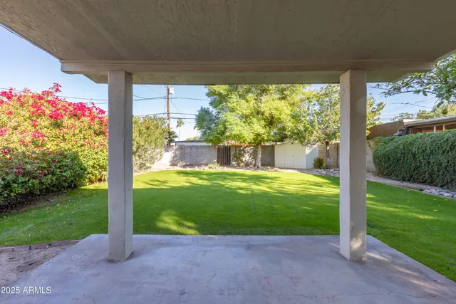 a view of a house with backyard from a patio
