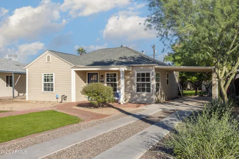 a front view of a house with a yard and outdoor seating
