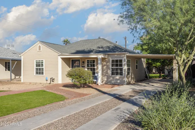 a front view of a house with a yard and outdoor seating
