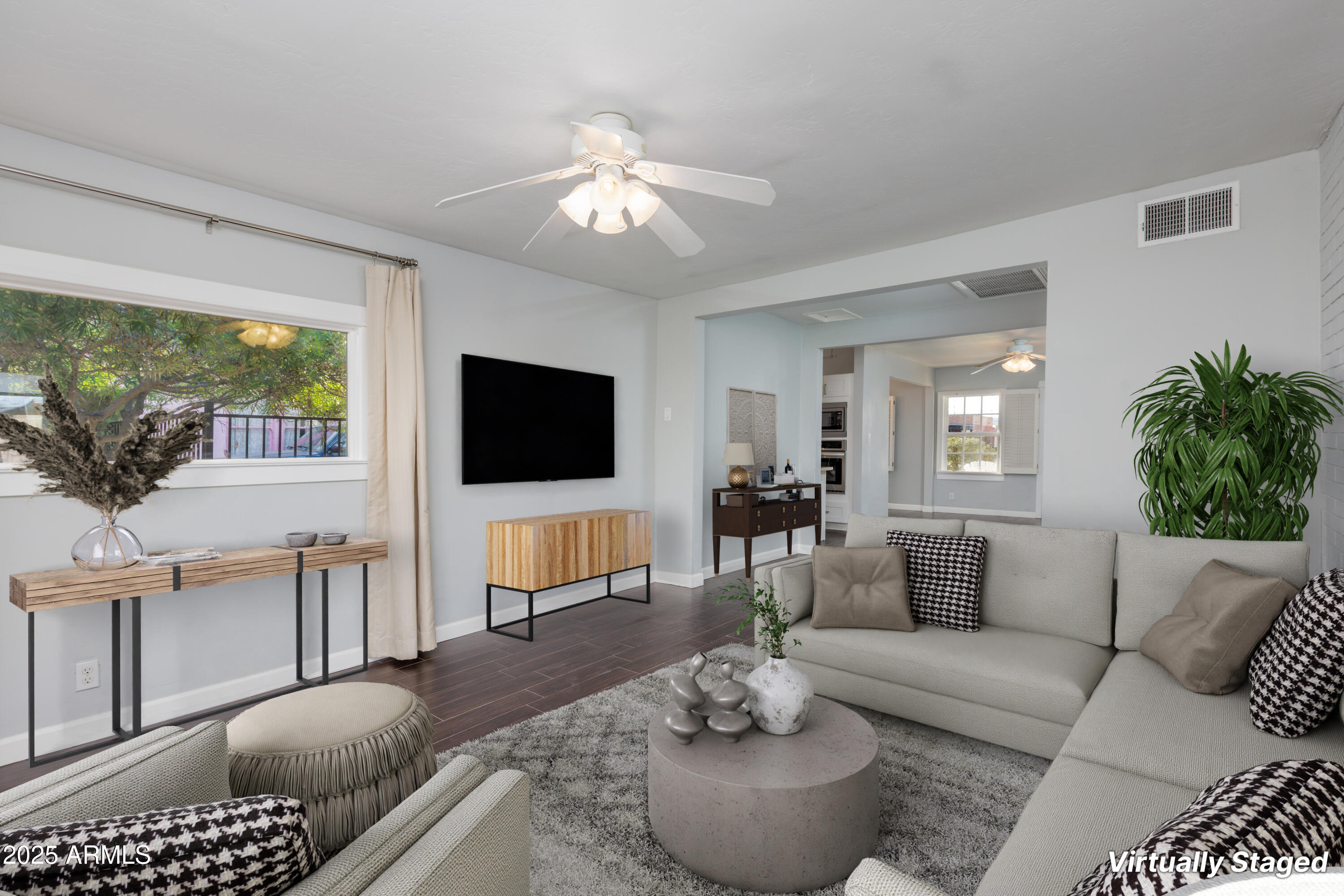 1621 North 16th Avenue Phoenix, AZ 85007 - Photo 9 of 32 a living room with furniture a flat screen tv and a large window