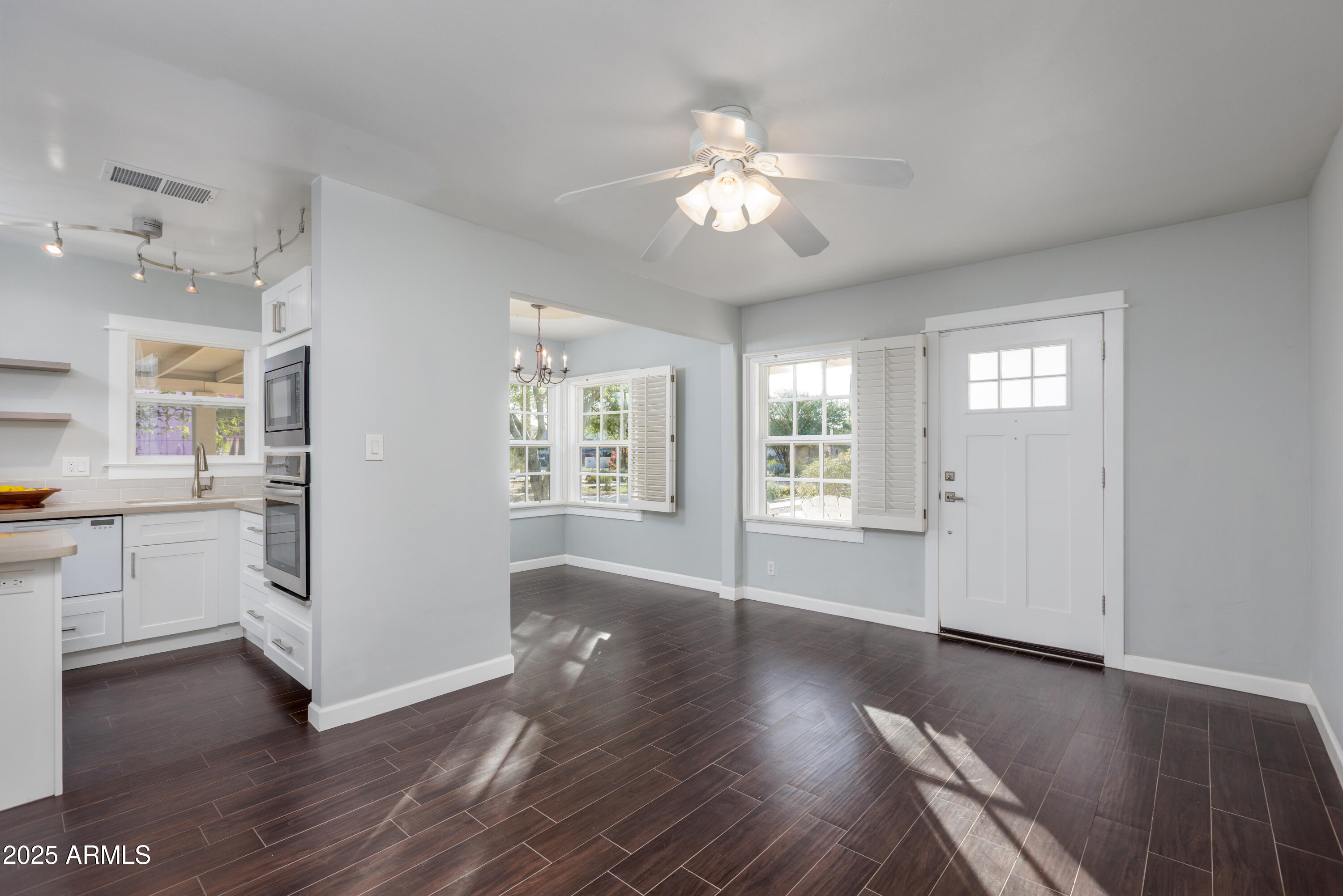 1621 North 16th Avenue Phoenix, AZ 85007 - Photo 10 of 32 a view of an empty room with a window and wooden floor
