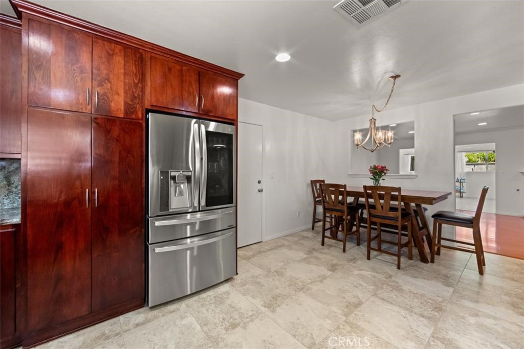 3275 Dalhart Avenue Simi Valley, CA 93063 - Photo 12 of 41 a kitchen with stainless steel appliances granite countertop a refrigerator and a stove top oven