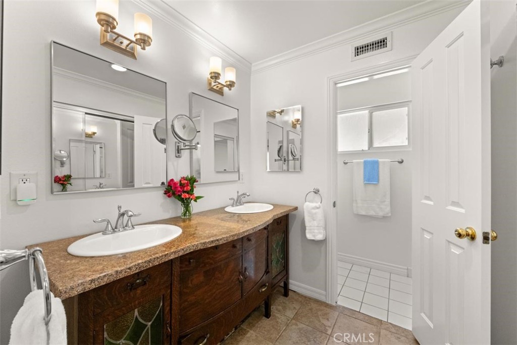 3275 Dalhart Avenue Simi Valley, CA 93063 - Photo 18 of 41 a bathroom with a granite countertop sink a mirror and shower