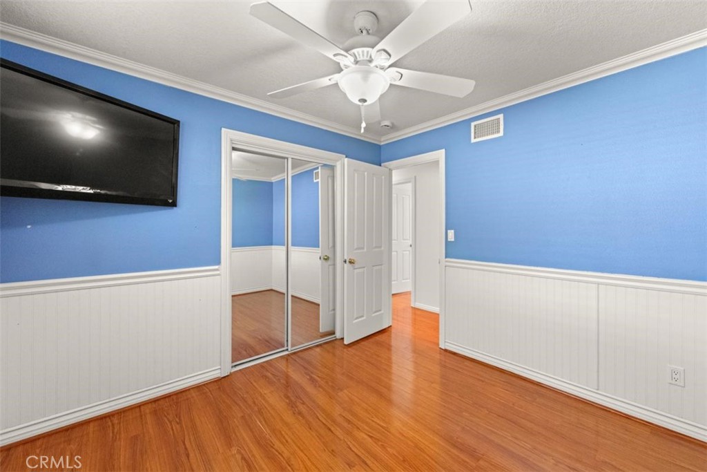 3275 Dalhart Avenue Simi Valley, CA 93063 - Photo 19 of 41 a view of an empty room with wooden floor and a ceiling fan