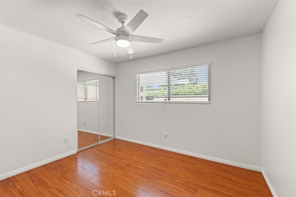 3275 Dalhart Avenue Simi Valley, CA 93063 - Photo 20 of 41 an empty room with wooden floor chandelier fan and windows