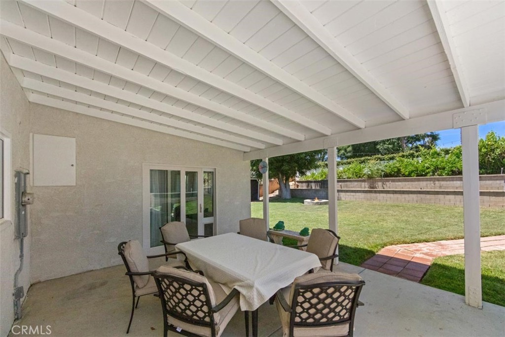 3275 Dalhart Avenue Simi Valley, CA 93063 - Photo 24 of 41 a view of a patio with a table chairs and a backyard