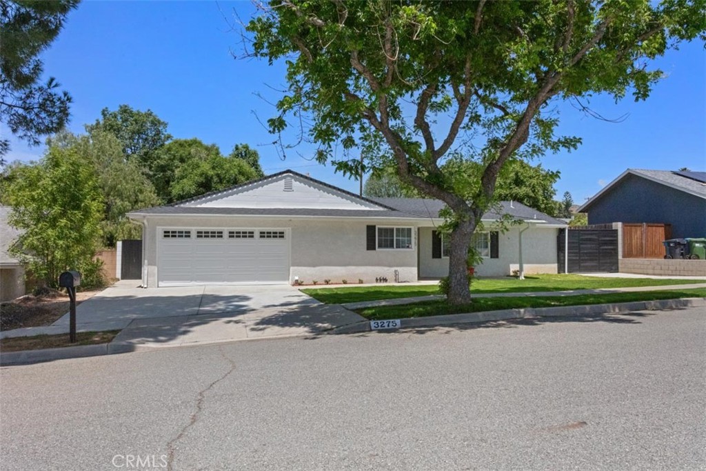 3275 Dalhart Avenue Simi Valley, CA 93063 - Photo 4 of 41 a front view of a house with a yard and garage