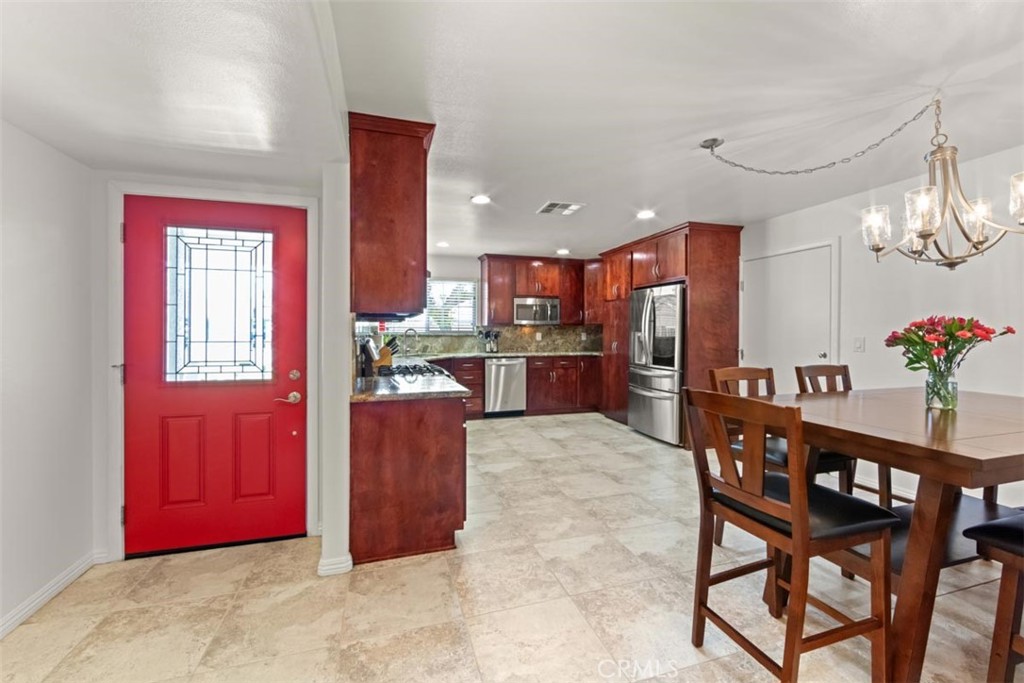 3275 Dalhart Avenue Simi Valley, CA 93063 - Photo 10 of 41 a kitchen with stainless steel appliances kitchen island granite countertop a refrigerator and microwave