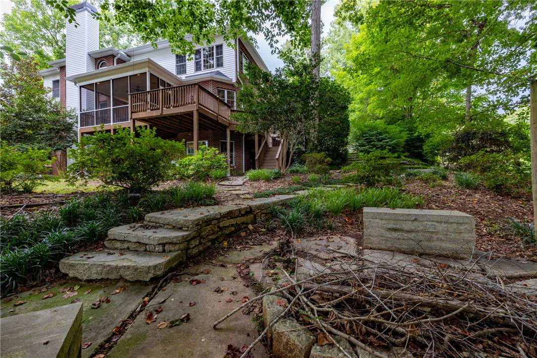 106 Red Maple Way Clemson, SC 29631 - Photo 42 of 49 Mature trees frame a multi-level deck and screened porch overlooking stone pathways.